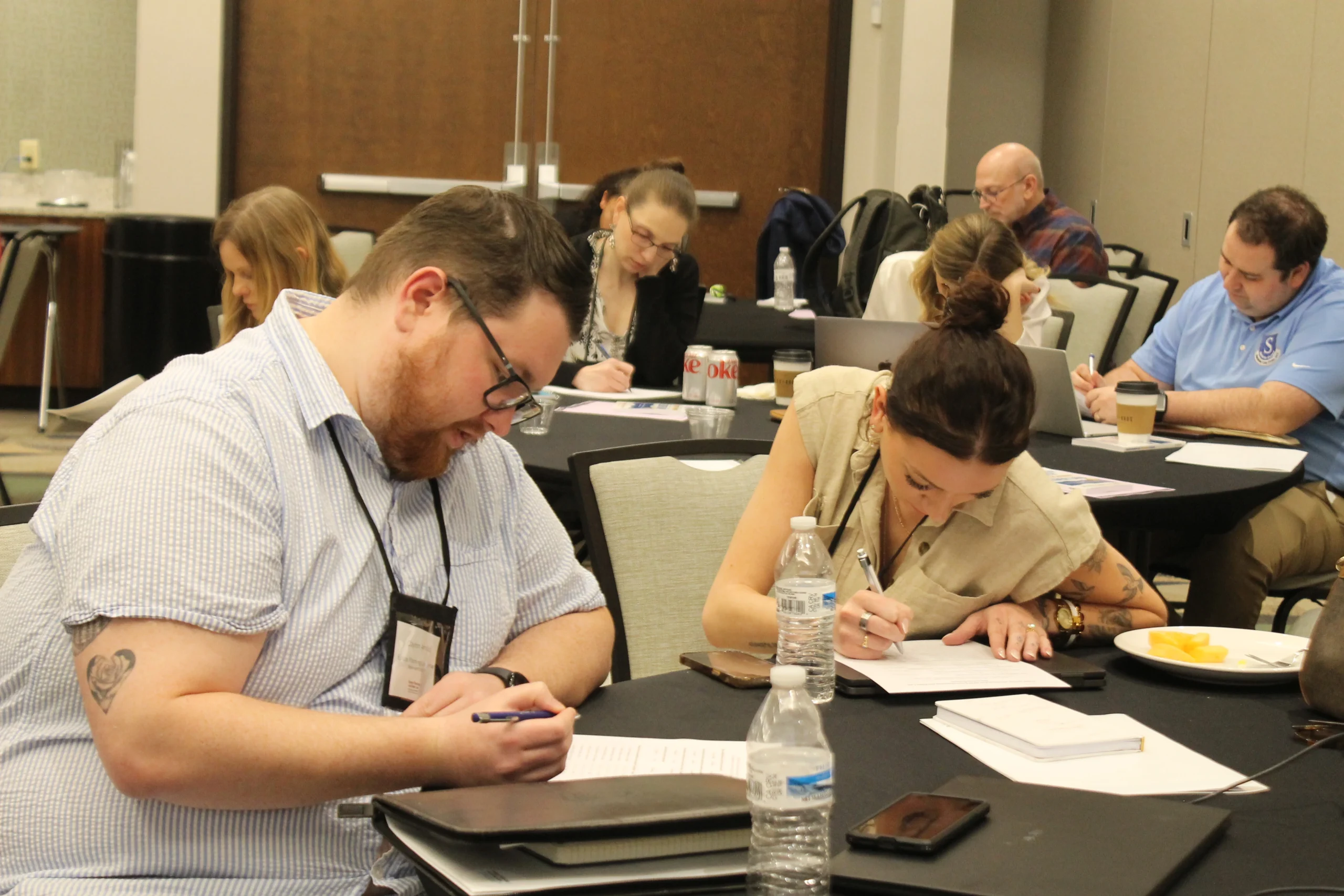 Attendees taking notes during a session